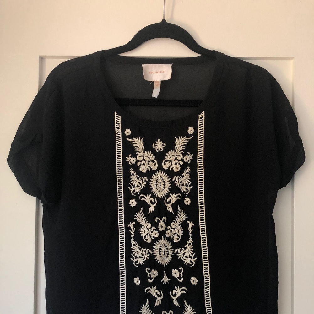 Black top with white embroidered panel